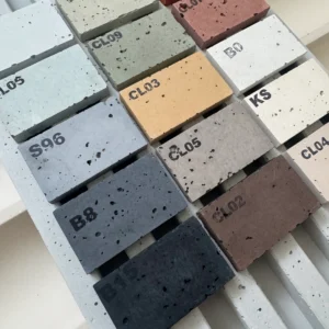 Vielfältige Betonmuster-Farbpalette auf Betonraster präsentiert. Nahaufnahme verschiedener Farbtöne und Texturen für Architekten und Designer zur Auswahl passender Materialien.